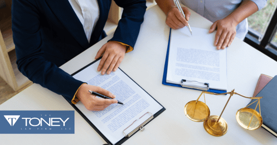 attorney and client looking at paperwork together