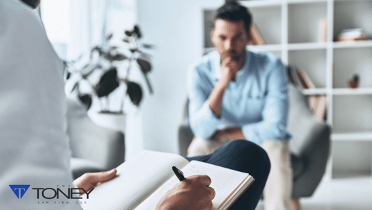 Two people talking while one takes notes