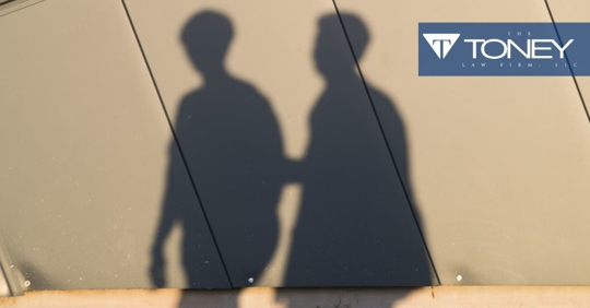 shadows of two people with one reaching out toward the other