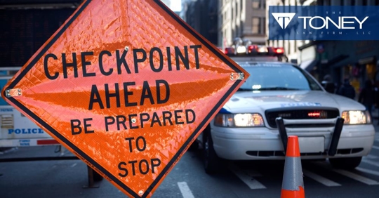 dui checkpoint sign with a police car parked next to it